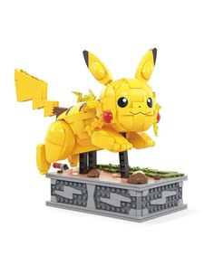 a yellow lego pokemon figure sitting on top of a blocky pile of rubbles