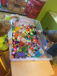 two children playing with toys in a play room