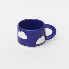 a blue cup with white clouds on it