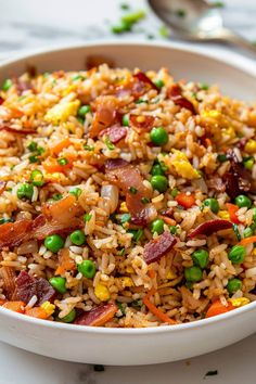 a white bowl filled with rice, peas and bacon