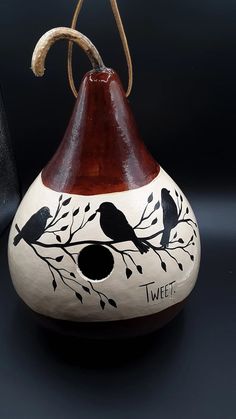 a vase with two birds painted on it and the words tweet written in black