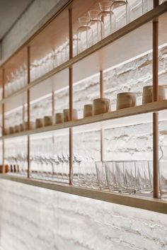 rows of wine glasses are lined up on the wall