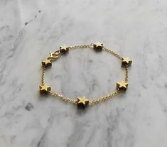 Morning Star. This bracelet is composed of 14K gold vermeil delicate chain and gold plated hematite tiny star charms, that shine and glow. So pretty and easy to wear! It also makes a very cute gift! Not sure which length to buy? We can add a 1 inch extender chain. Just write a note at checkout! ❈ We send all our items with registered mail. ❉ Due to the organic nature of stones, there might be a slight variation in colour, size and shape. ✺ All items come packaged in a quality velvet pouch ready Dainty Star-shaped Bracelets For Everyday Wear, Adjustable Gold Chain Bracelet With Star Charm, Adjustable Gold Star Chain Bracelet, Adjustable Gold Star-shaped Chain Bracelet, Gold Charm Bracelet With Star Charm As A Gift, Gold Star Bracelets For Everyday, Gold Bracelets With Star Charm For Gift, Gold Bracelet With Star Charm For Gift, Gold Bracelet With Star Charm As Gift