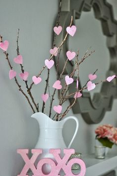 a vase filled with pink hearts on top of a table