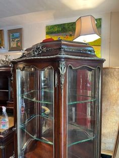 an antique china cabinet with glass doors in a living room