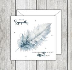 a greeting card with an image of a feather on it and the words, sympathy