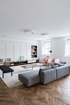 a modern living room with wood floors and white walls