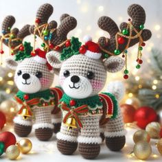 two crocheted reindeers are standing next to each other in front of christmas decorations