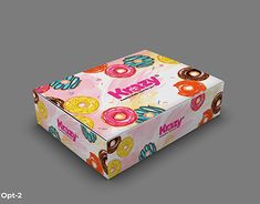 the box is decorated with donuts and sprinkles on it's wrapper