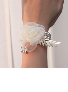 a woman's hand wearing a white flower bracelet