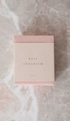 rose geranium soap in a pink box on a marble surface with the words, rose geranium