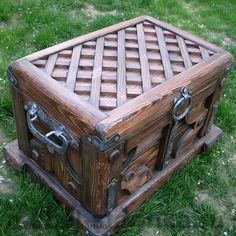 an old wooden trunk sitting in the grass