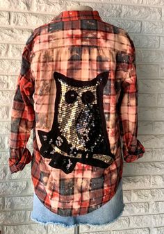 the back of a plaid shirt with sequins and an owl on it's chest