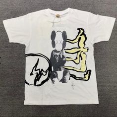 Brand New With Bagg White Graffiti Print Shirt For Streetwear, Urban Cotton Shirt With Graffiti Print, Tan Shirt For Summer Streetwear, White Relaxed Fit Shirt With Graffiti Print, Tan Graphic Print Shirt For Streetwear, Tan Shirt With Graphic Print For Streetwear, Kaws White, Heart Tee Shirt, Uniqlo Shirt