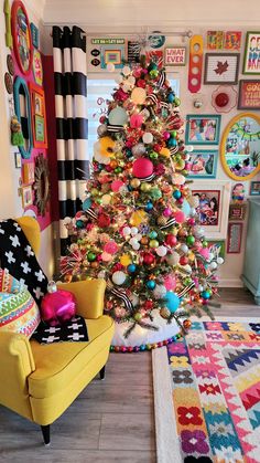 a brightly colored christmas tree in a living room decorated with colorful ornaments and decorating