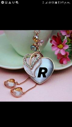 a heart shaped keychain with the letter r on it