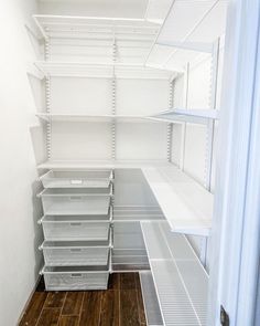 an empty closet with shelves and bins