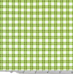 a green and white checkered fabric that has been cut into squares with a ruler