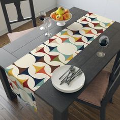 a dining table with place settings and fruit on it