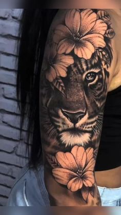 a woman's arm with a tiger and flowers on it