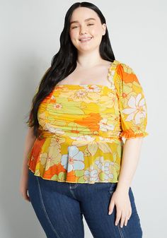 Whether you’re making an escape uptown, upstate, or to the opposite coast, this flirty yellow blouse is a must-pack item for your next getaway thanks to its soft mesh fabrication, vintage-inspired design, and exclusive hand-drawn floral print plastered all over. Shirring at the fitted bodice, short puff sleeves with elasticized ruffle cuffs, ruffle-trim at the square-neckline, a smocked panel at the back for ease of fit, and a subtle peplum hem, show how this ultra-feminine shirt was thoughtfull Fitted Flutter Sleeve Summer Peplum Top, Summer Floral Print Peplum Top, Fitted Floral Print Peplum Top, Vintage Style Swimwear, Yellow Floral Print Button-up Top, Feminine Shirts, Designer Plus Size Clothing, Summer V-neck Peplum Top With Ruffle Hem, Casual Dresses Plus Size