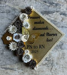 a graduation cap with flowers and butterflies on it that says pressure makes diamonds and nurses too