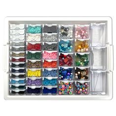 a white drawer filled with lots of different types of beads