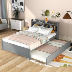 a bed sitting on top of a hard wood floor next to a book shelf filled with books