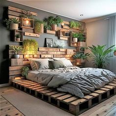 a bed made out of wooden pallets with plants on the headboard and pillows