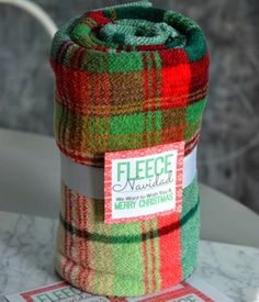 a green and red plaid blanket sitting on top of a table