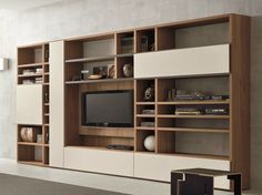 a living room with a large entertainment center in the middle and shelves on both sides