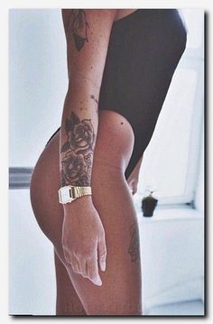 a woman with tattoos on her arm and leg