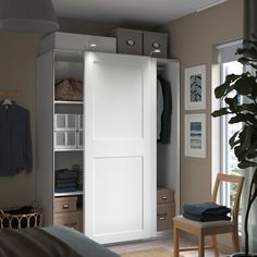 a bedroom with a bed, chair and closet