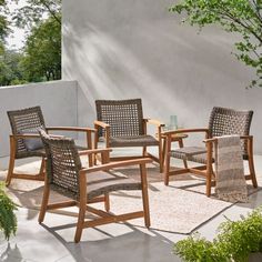 a set of four chairs sitting on top of a patio