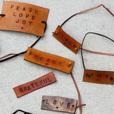 several pieces of wood that say peace, love, joy and grateful on the ground