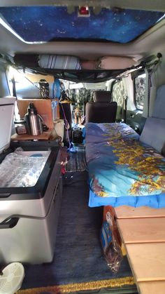 the inside of a van with beds and coolers