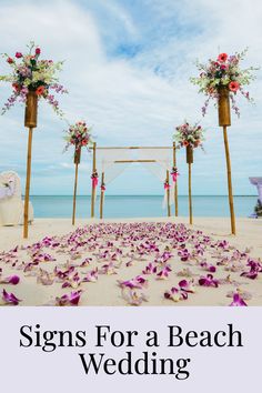 a beach wedding with flowers on the sand