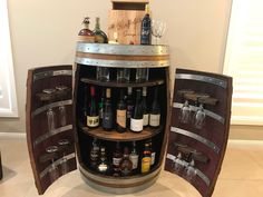 there is a wine barrel with many bottles in it