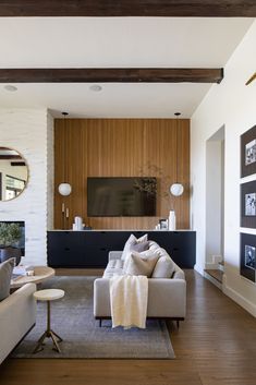 a modern living room with wood paneling and white walls