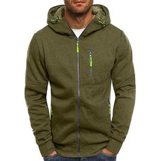 a man wearing a green hoodie with zippers on the front and side pockets