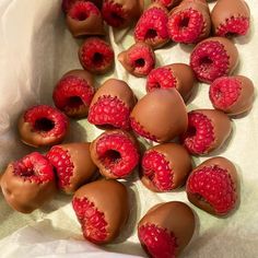 chocolate covered raspberries are sitting on the table