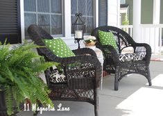 two wicker chairs sitting on the front porch