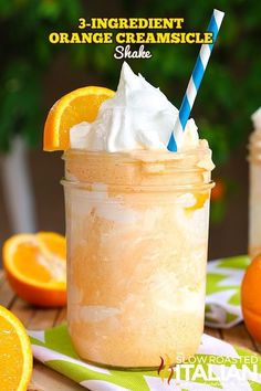 orange creamsice shake in a mason jar with blue and white striped straw