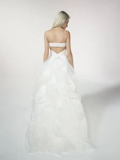 a woman in a white wedding dress standing back to back