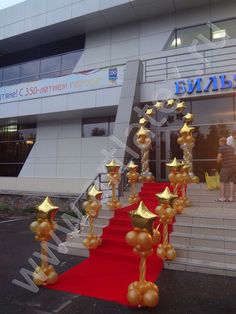 an entrance to a building with red carpet and gold stars on the steps leading up to it