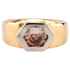 Center Stone: Hexagon Cut Diamond Weight: 1.29 Carat Color: Fancy Brown Clarity: SI Metal: 18K Yellow Gold and Platinum Era: Contemporary Circa: 2010's Hallmarks: Purity Marks Size: 5.75 and can be resized Gram weight: 14.9 This striking contemporary band, crafted in a blend of 18K yellow gold and platinum, features a unique 1.29 carat hexagon cut diamond. The diamond, with its rare fancy brown color and SI clarity, creates a bold and modern aesthetic. Hallmarked with purity marks and weighing a substantial 14.9 grams, this piece from the 2010s is sized at 5.75. Its geometric design and the warm hue of the diamond against the yellow gold make this ring a truly distinctive and elegant statement piece. Memory Ring, Yellow Gold Cocktail Ring, Unique Rings Vintage, Platinum Diamond Engagement Rings, Fancy Yellow Diamond, Platinum Diamond Rings, Gold Cocktail Ring, Right Hand Rings, Hand Ring