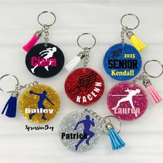 six personalized key chains with tassels are shown in different colors and designs