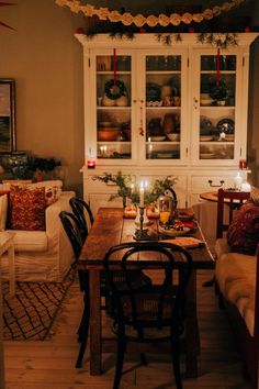 a dining room table with candles on it