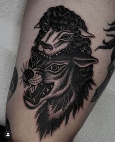 a close up of a person's leg with a tattoo on it and an animal head