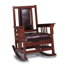 a wooden rocking chair with brown leather upholstered on the seat and backrest